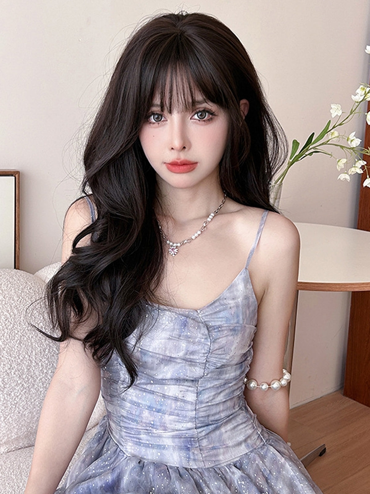 Long wavy black wig with airy flush bangs, 62cm, from Inthemask by Moli's, showcasing soft waves and layered style.