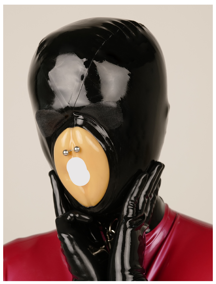 Black rubber latex mask by InTheMask, "The Devourer" with fake pussy mouth and micropores, featuring detailed textured surface.