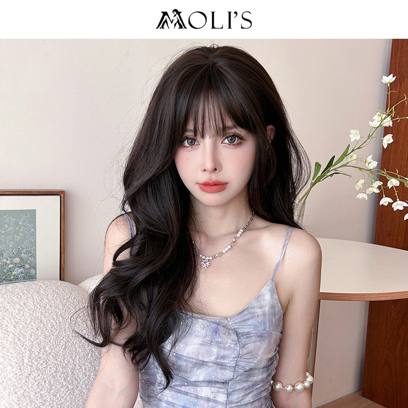 Long wavy black wig with airy flush bang, 62cm, by Inthemask by Moli's, showcasing flowing, textured hair with layered style.