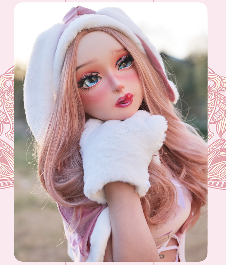 Neogan Cherrie female doll mask by Inthemask with pink latex hood, detailed face, and included gag accessory.